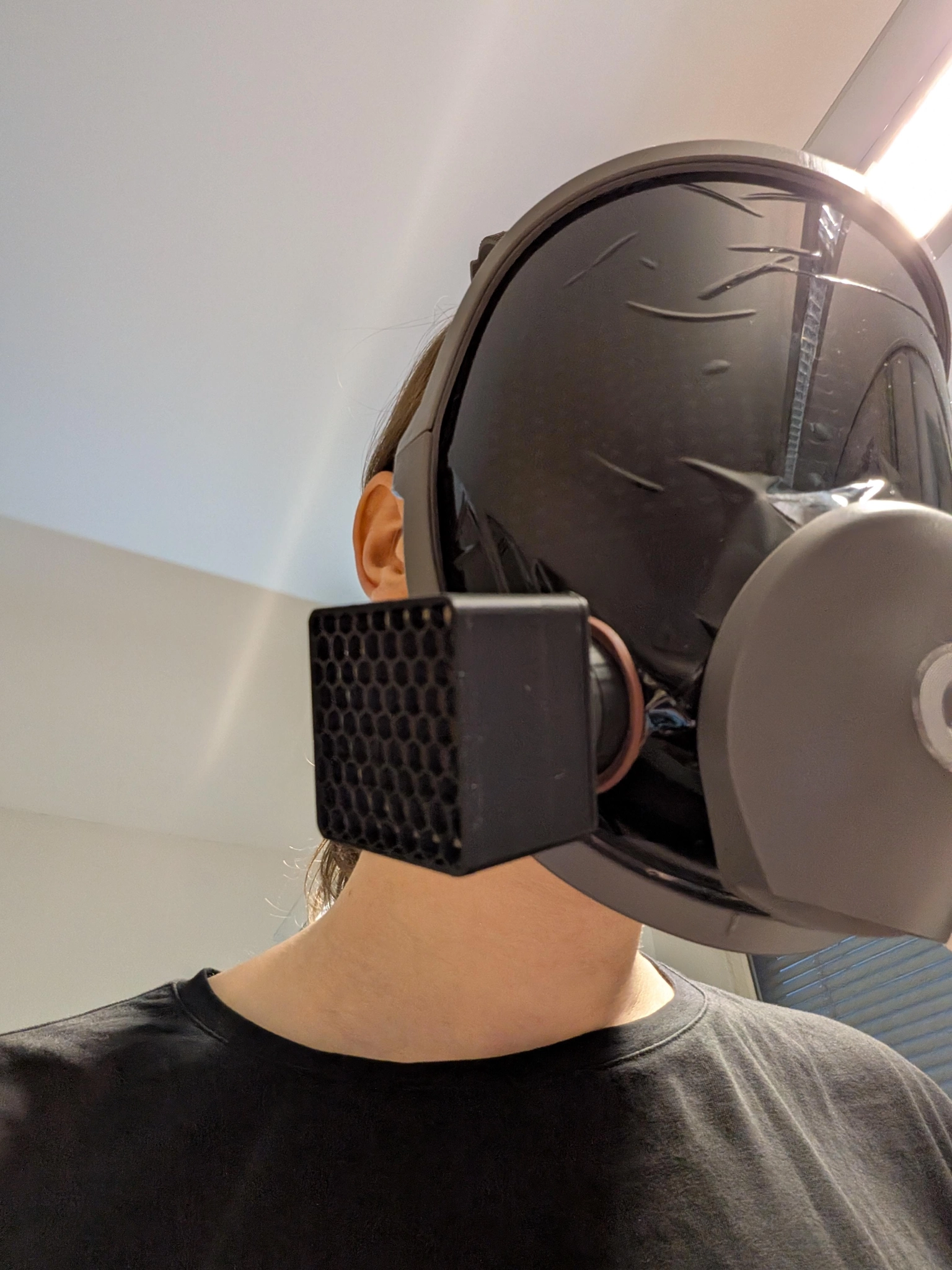 beeper with a visor has a black 3d printed object mounted to one of its filter ports