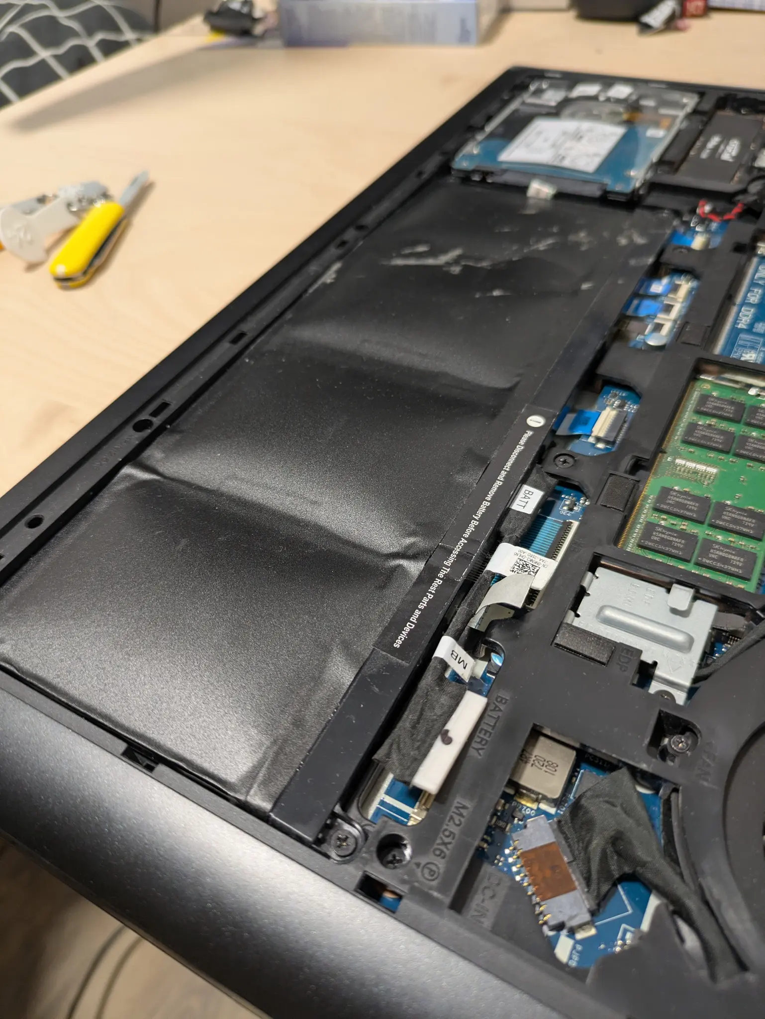 back of an opened laptop
bulging battery pack